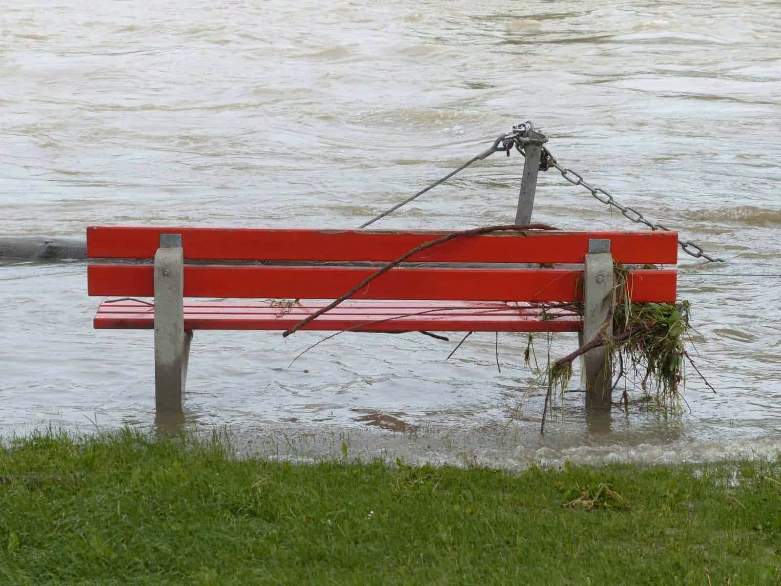 Park bench surrounded by flood water