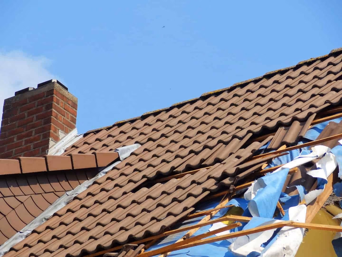 Tile roof torn open by a storm
